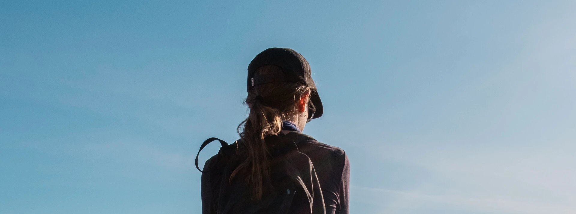 Hiker on mountain trail — terrain the Hoka Speedgoat 7 is built for