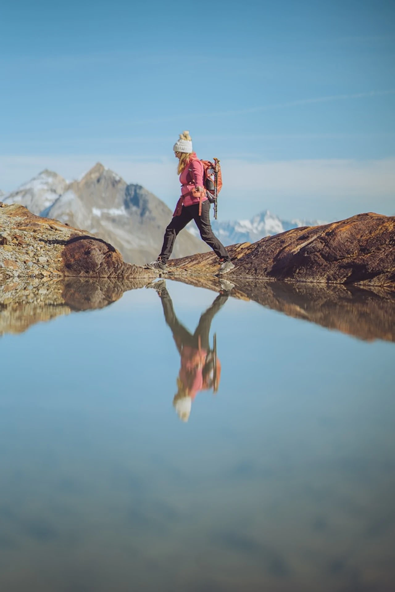 Hiker crossing alpine terrain — the all-day comfort scenario the Merrell Moab 3 is built for